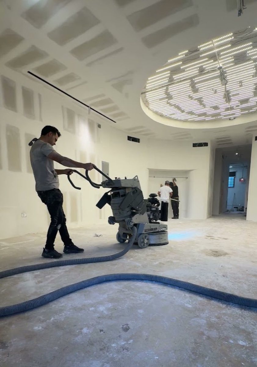 Suncrete Coatings technician diamond-grinding a commercial concrete floor