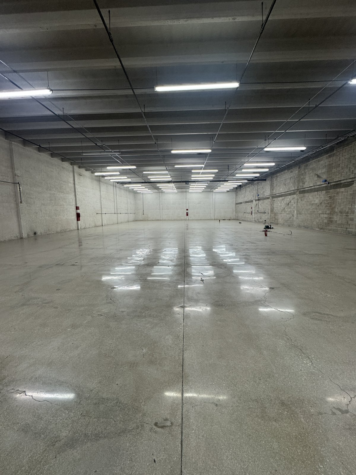 Polished concrete hallway running the length of a warehouse building